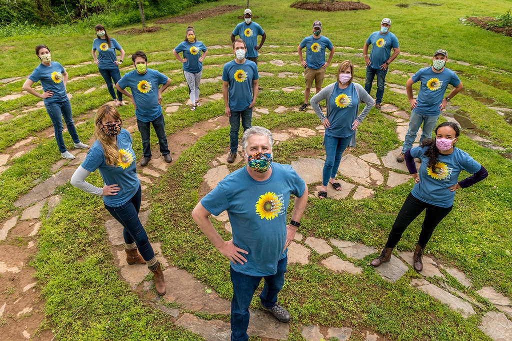 CooperRiis staff stand in a defiant pose all wearing masks