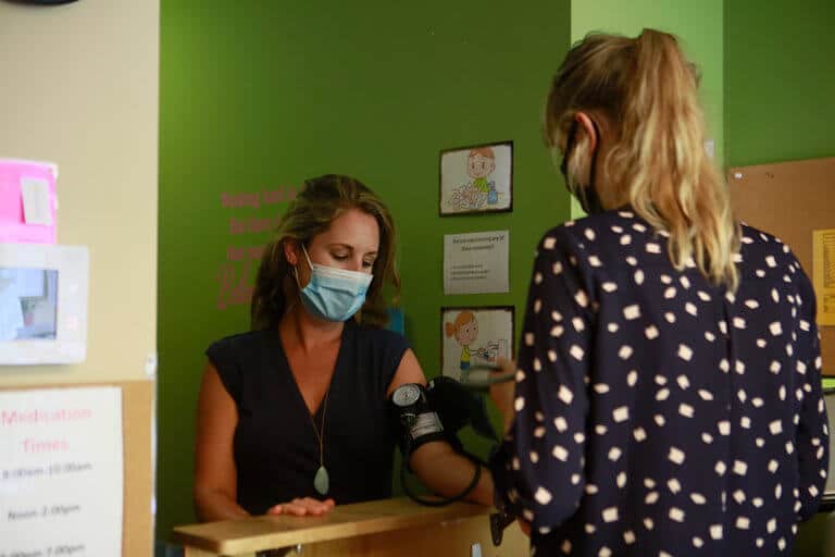 woman having her blood pressure taken