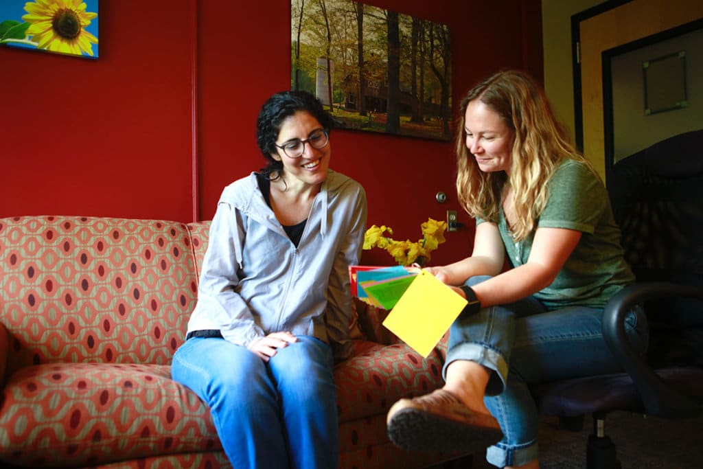 women looking at colored cards