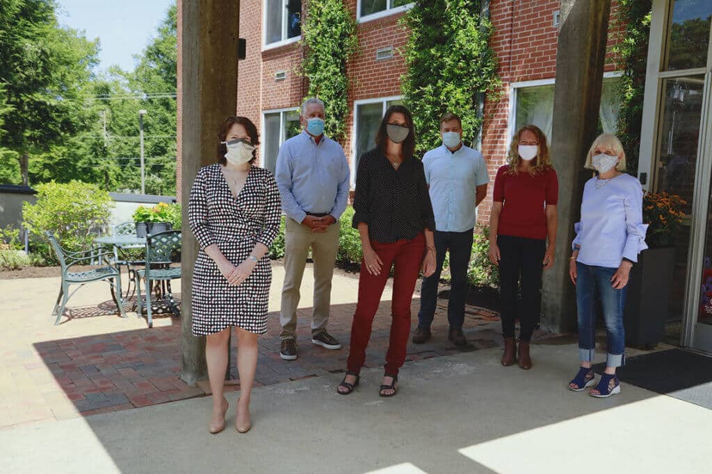 A group of senior staff wearing masks at Asheville Campus