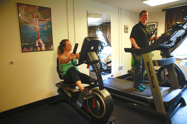 woman on exercise bike and woman on treadmill