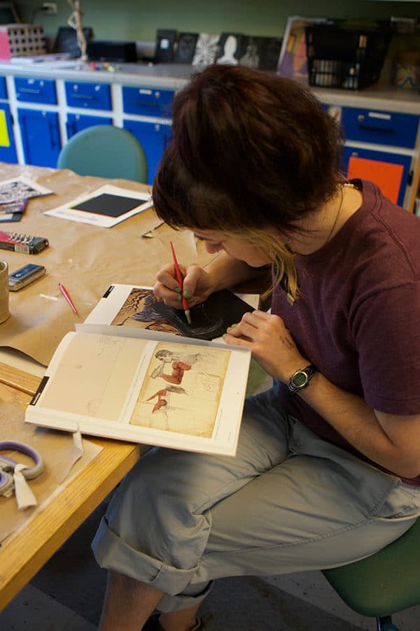 girl drawing on art book