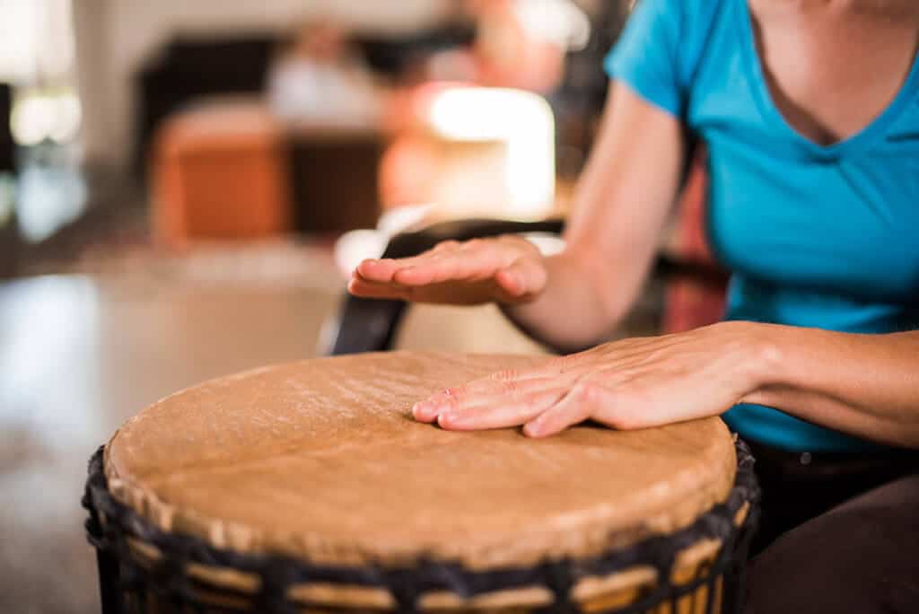 closeup of hands playing drum