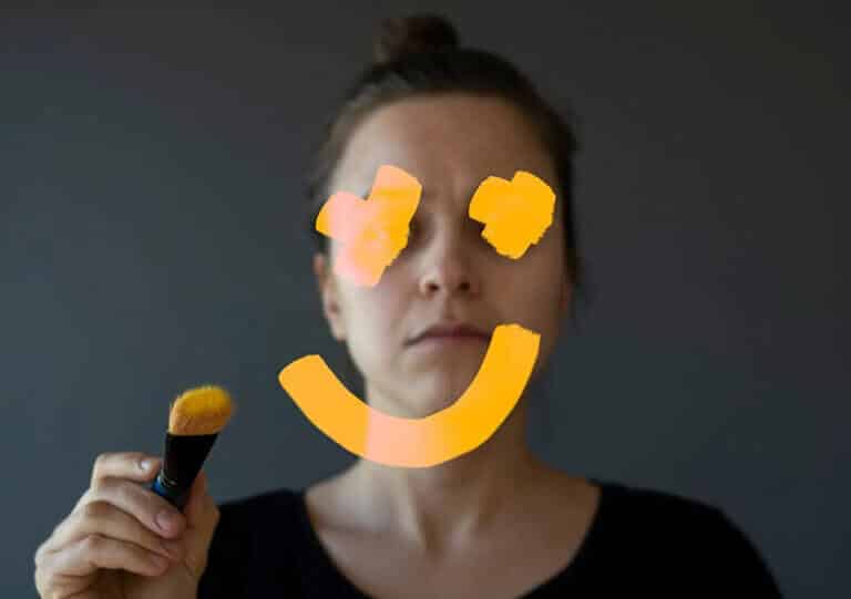 woman with smiley face painted over face
