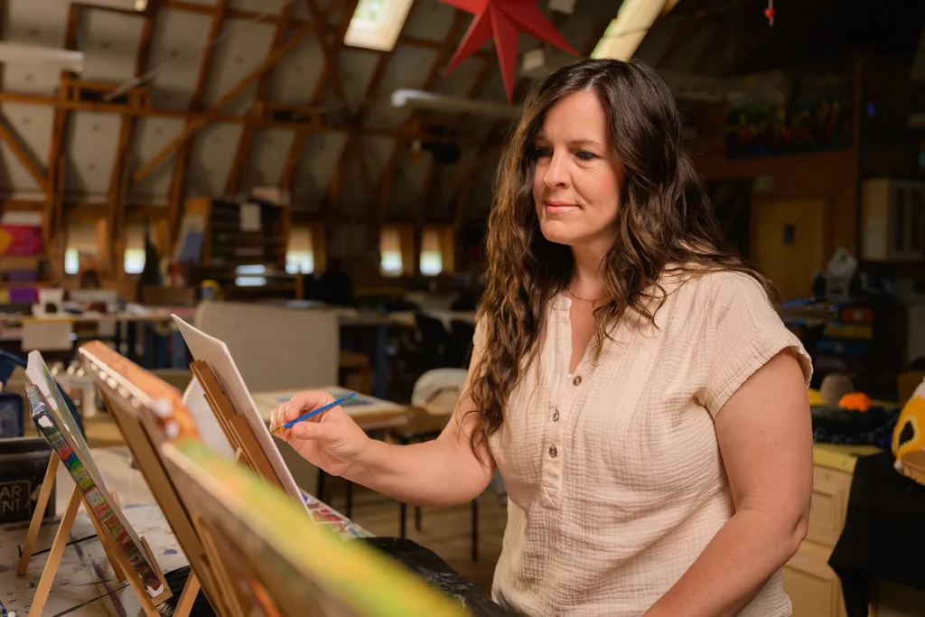 A woman paints using art as therapy for mental health recovery